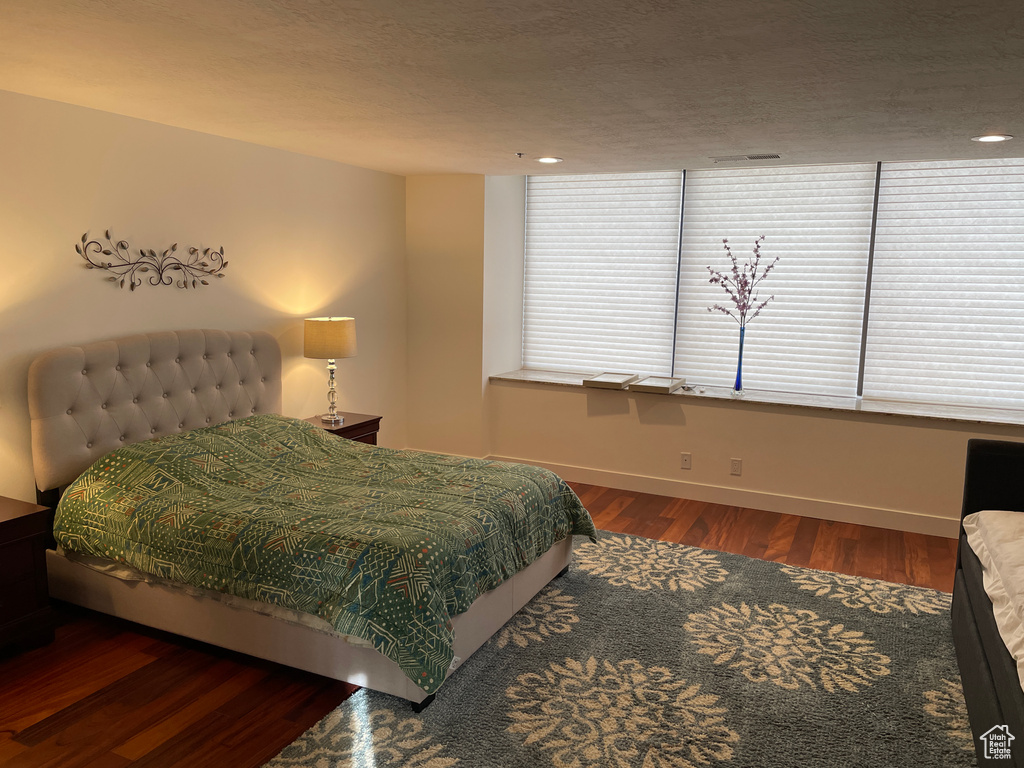Bedroom featuring wood finished floors and baseboards