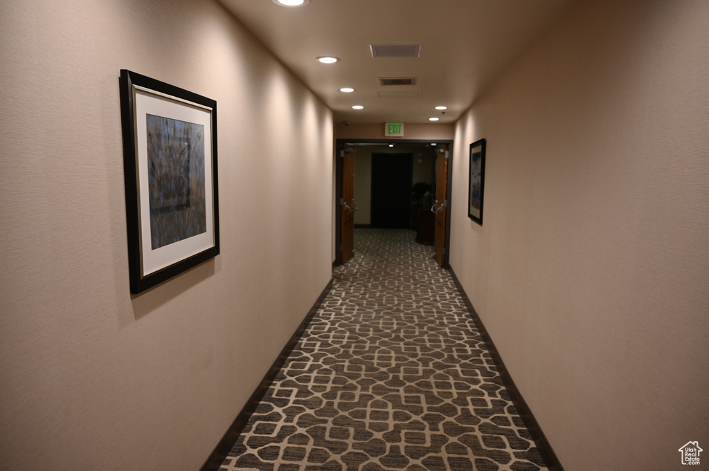 Corridor featuring recessed lighting, baseboards, and stone finish floors