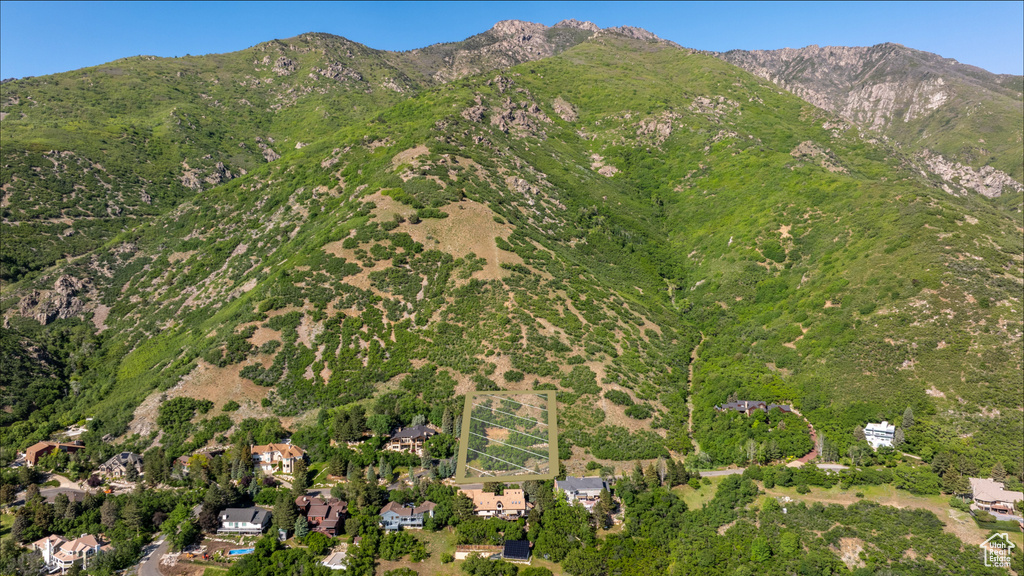 Aerial view of property and surrounding area with a mountainous background