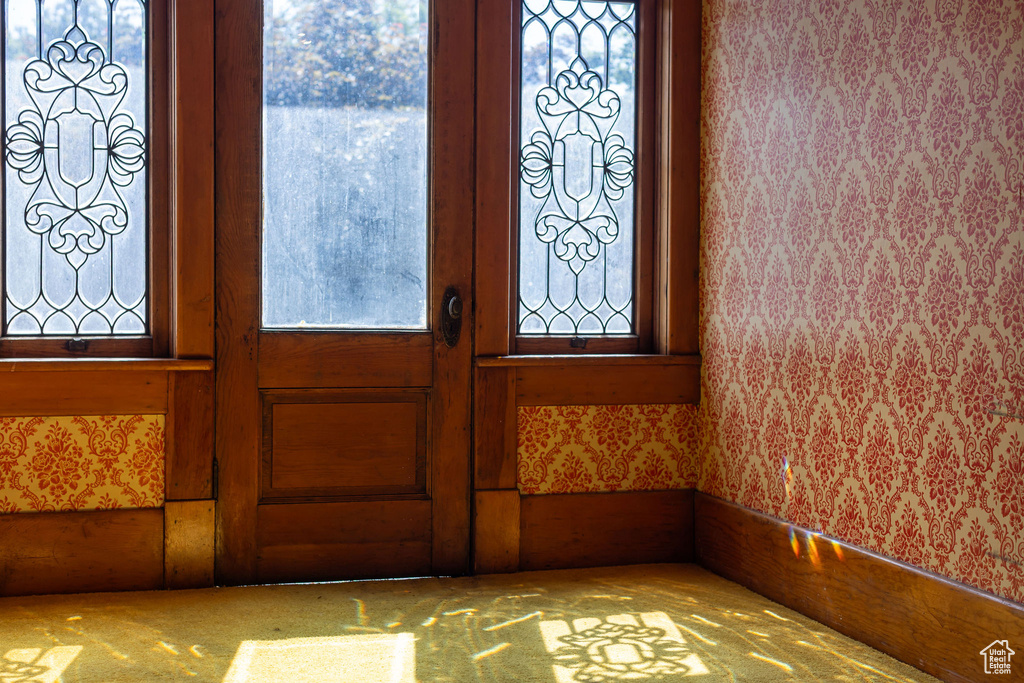 Foyer entrance featuring wallpapered walls