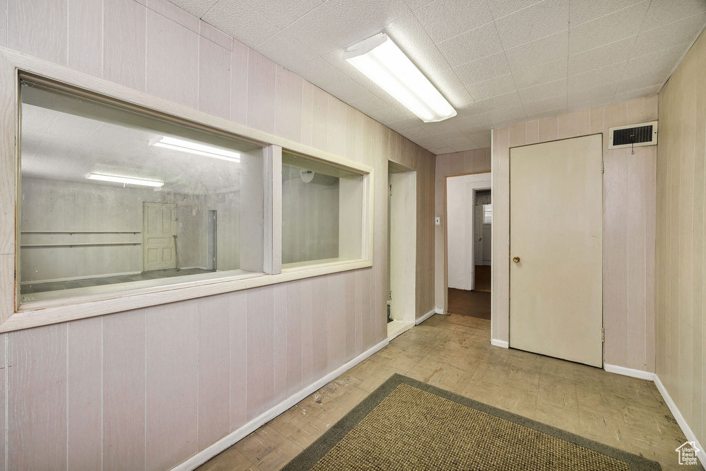 Hall featuring wood finished floors and baseboards
