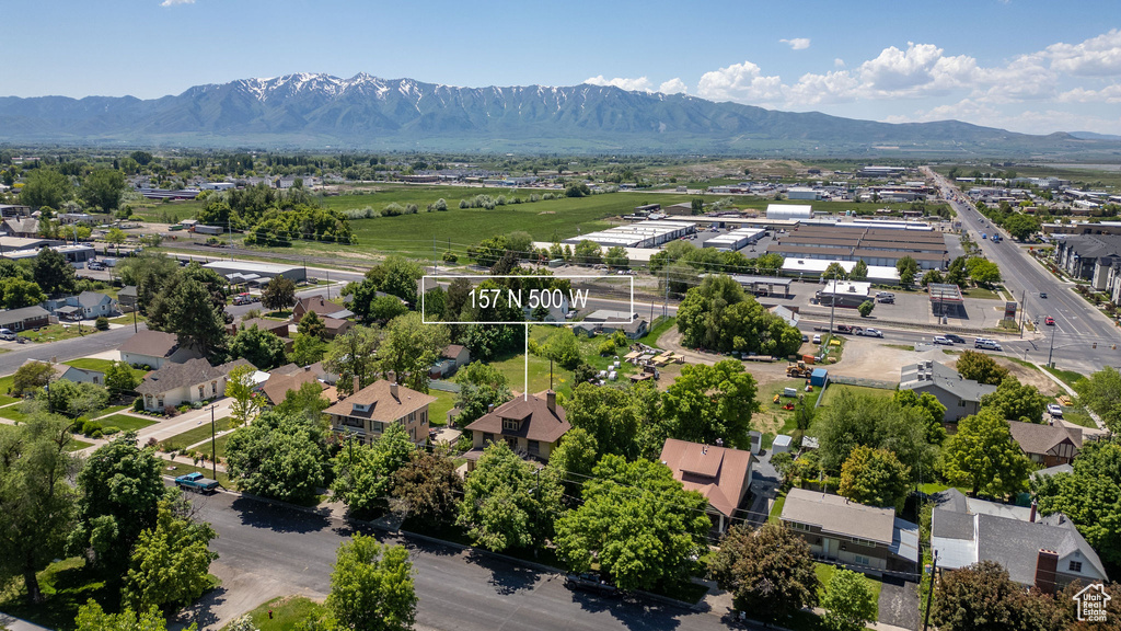 Aerial perspective of suburban area featuring a mountainous background