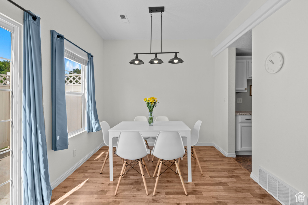 Dining space with light wood finished floors and baseboards