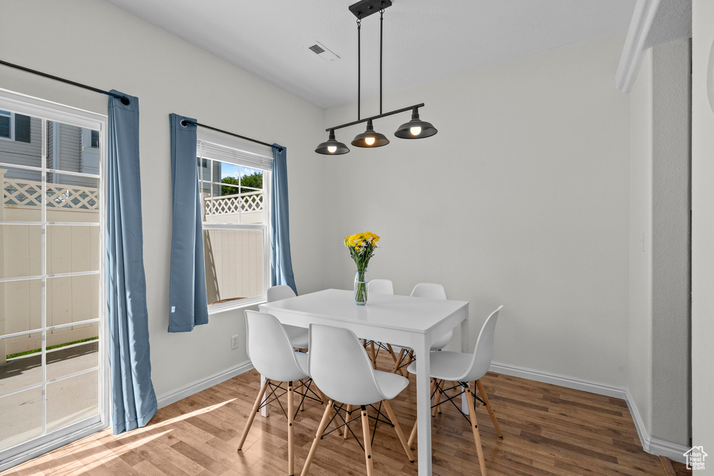 Dining space with wood finished floors and baseboards