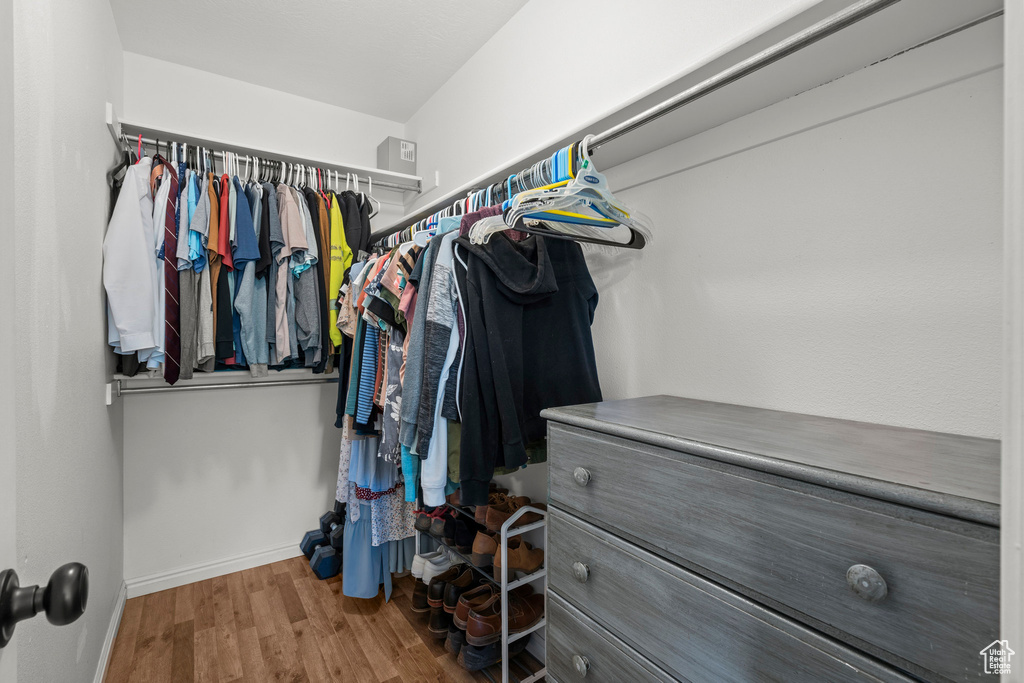 Walk in closet featuring wood finished floors