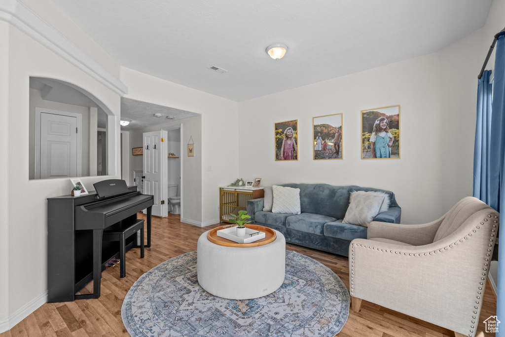 Living room featuring light wood-type flooring and baseboards