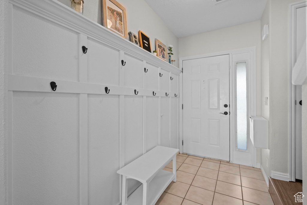 Mudroom with light tile patterned flooring and baseboards