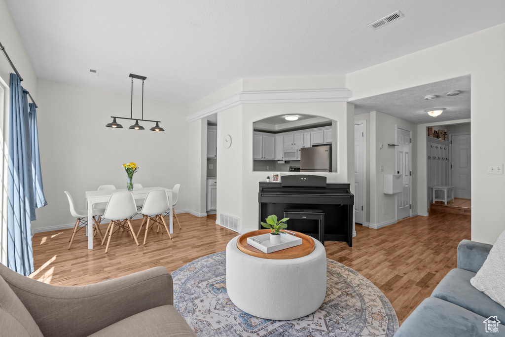 Living area with light wood-type flooring and baseboards