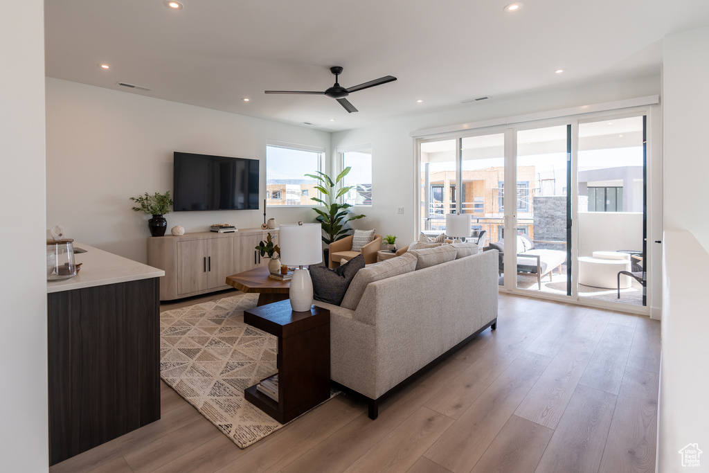 Living area featuring ceiling fan, light wood-style flooring, and recessed lighting