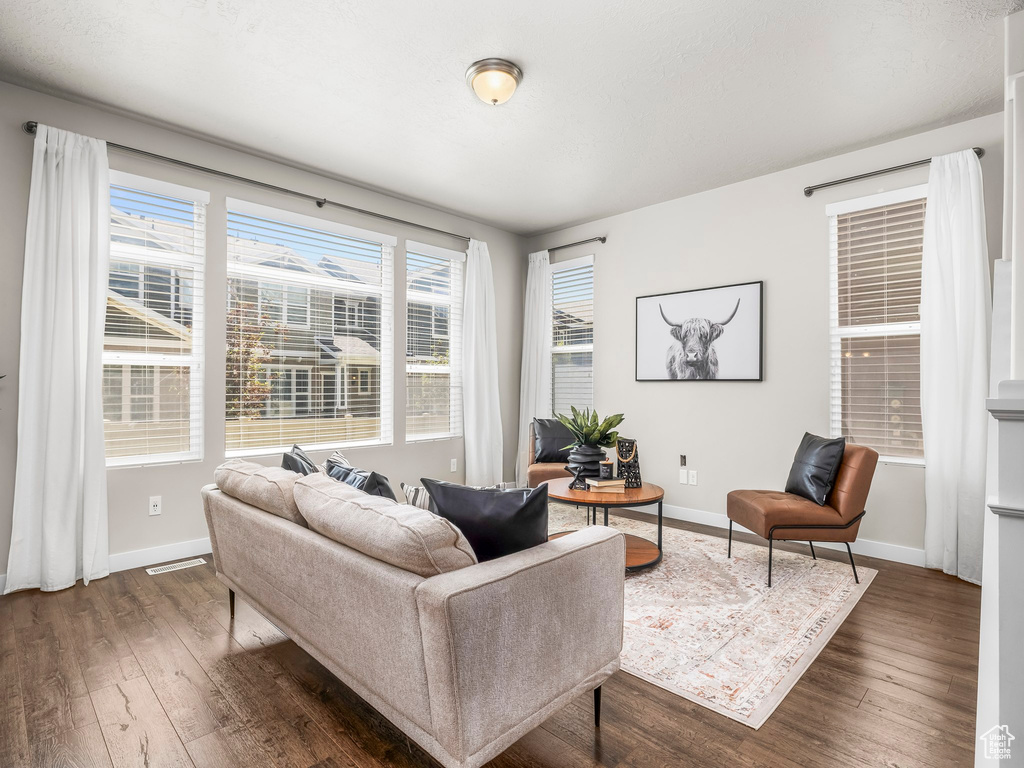 Living area featuring dark wood finished floors and baseboards