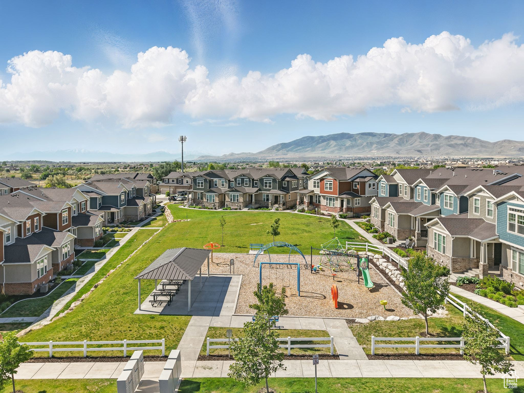 Aerial view of residential area with mountains and a park