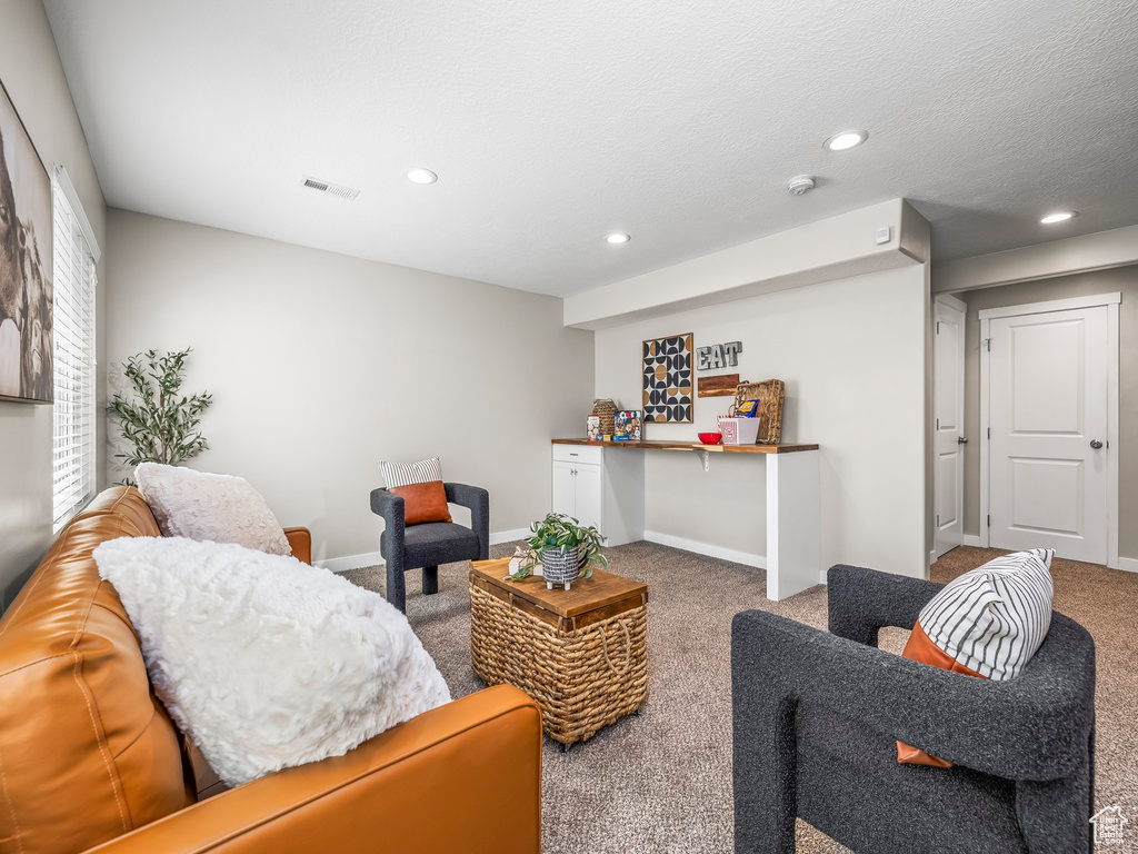 Living area featuring carpet, recessed lighting, and baseboards