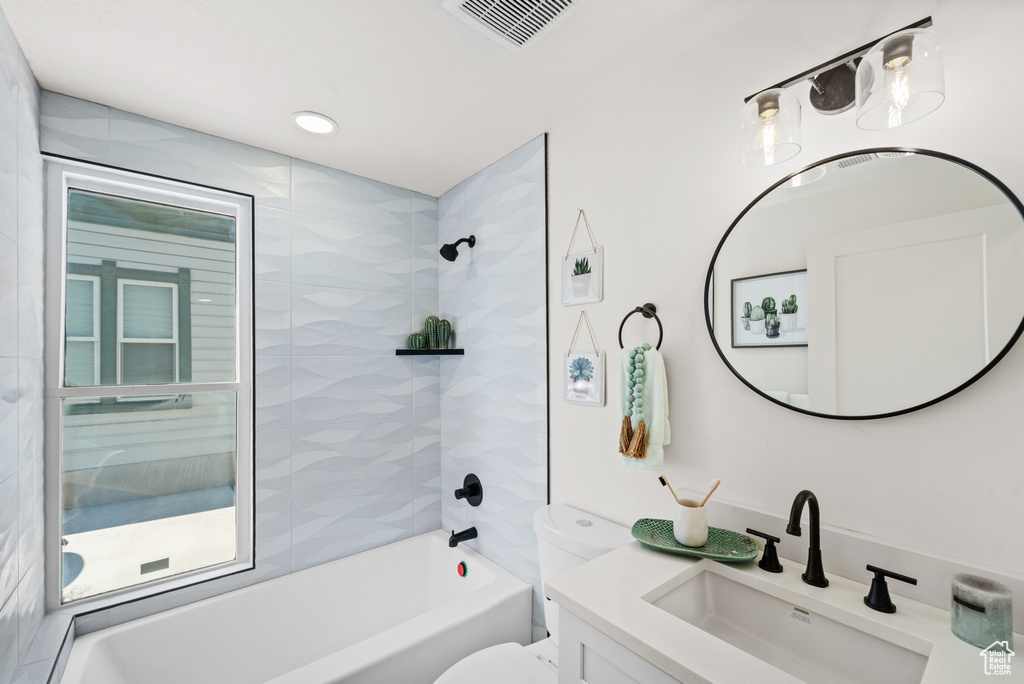 Bathroom with vanity, toilet, and shower / bathtub combination