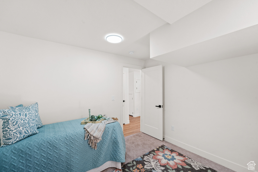 Bedroom featuring carpet and baseboards