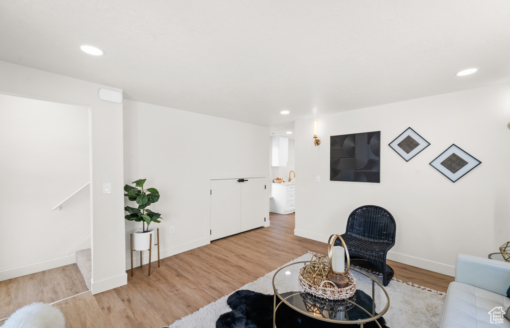 Living area featuring light wood-type flooring, recessed lighting, and baseboards
