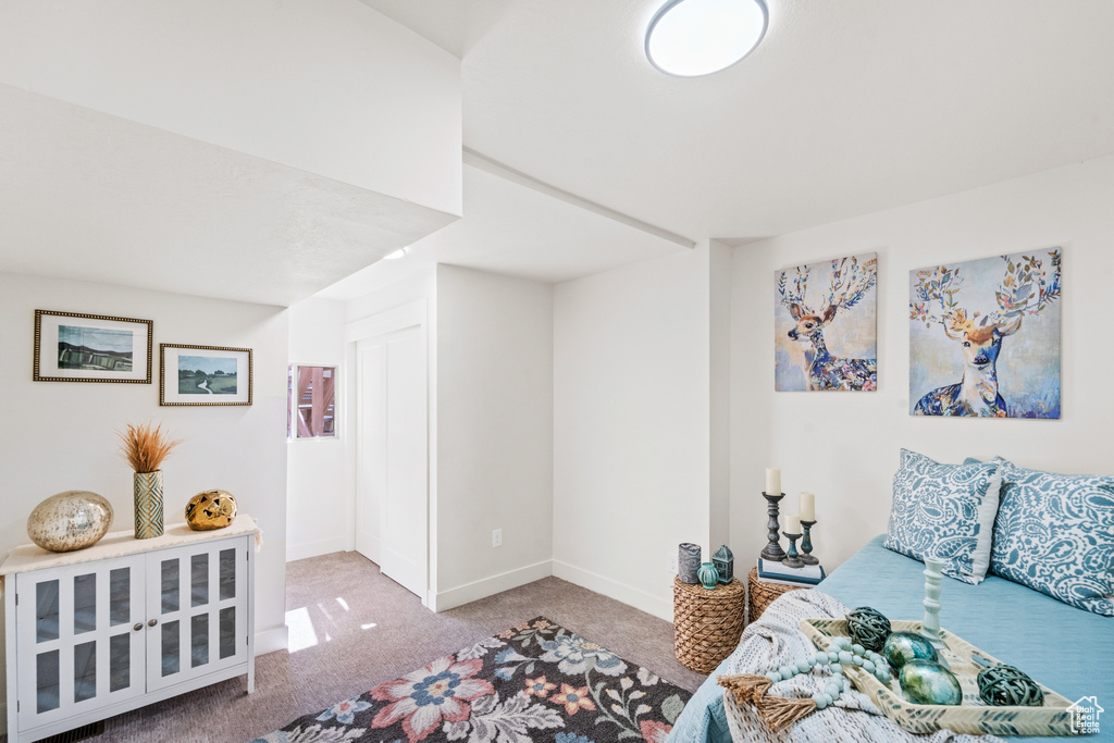 Bedroom featuring carpet flooring and baseboards