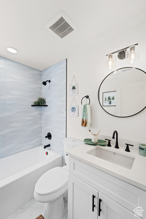 Bathroom featuring vanity, marble look tiles, bathing tub / shower combination, and toilet