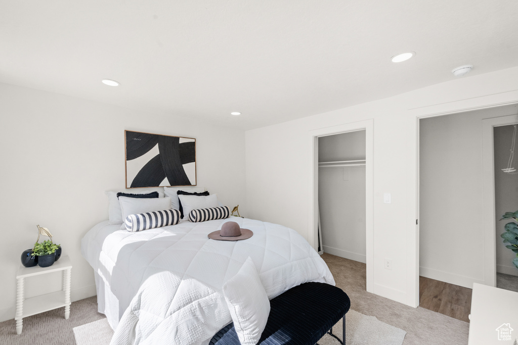 Bedroom featuring light colored carpet, recessed lighting, and a closet