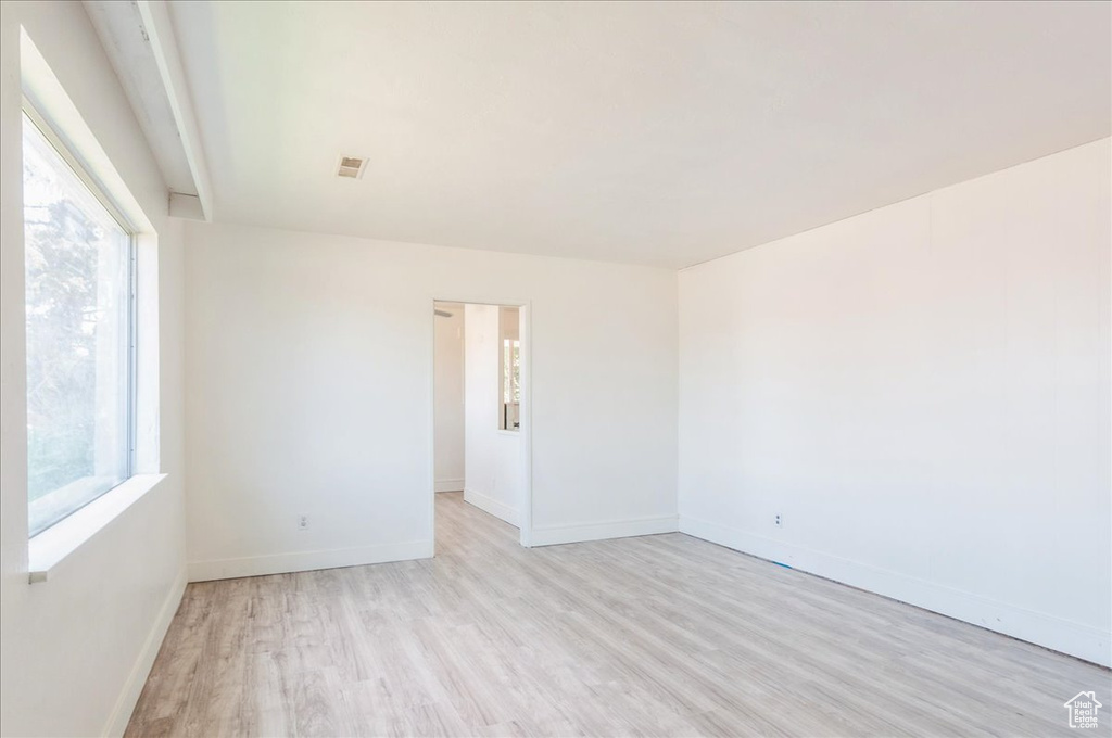 Spare room with light wood-type flooring and baseboards