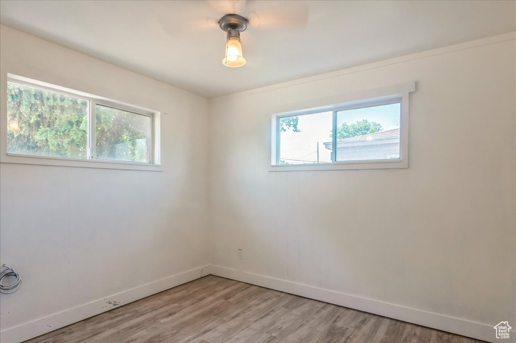 Unfurnished room featuring baseboards and light wood finished floors