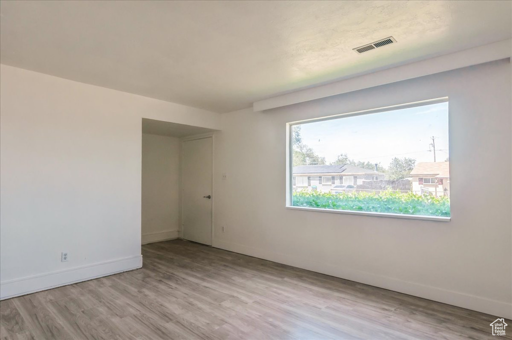 Empty room featuring wood finished floors and baseboards
