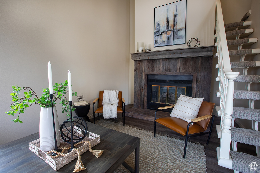 Living area with wood finished floors and a glass covered fireplace