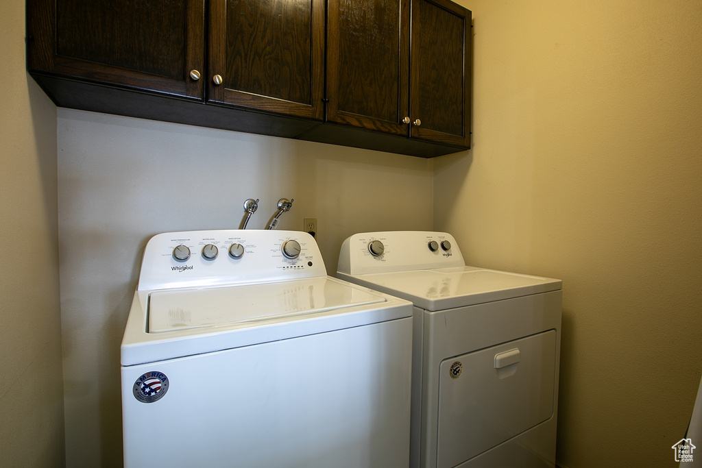 Laundry room featuring cabinet space and washer and clothes dryer