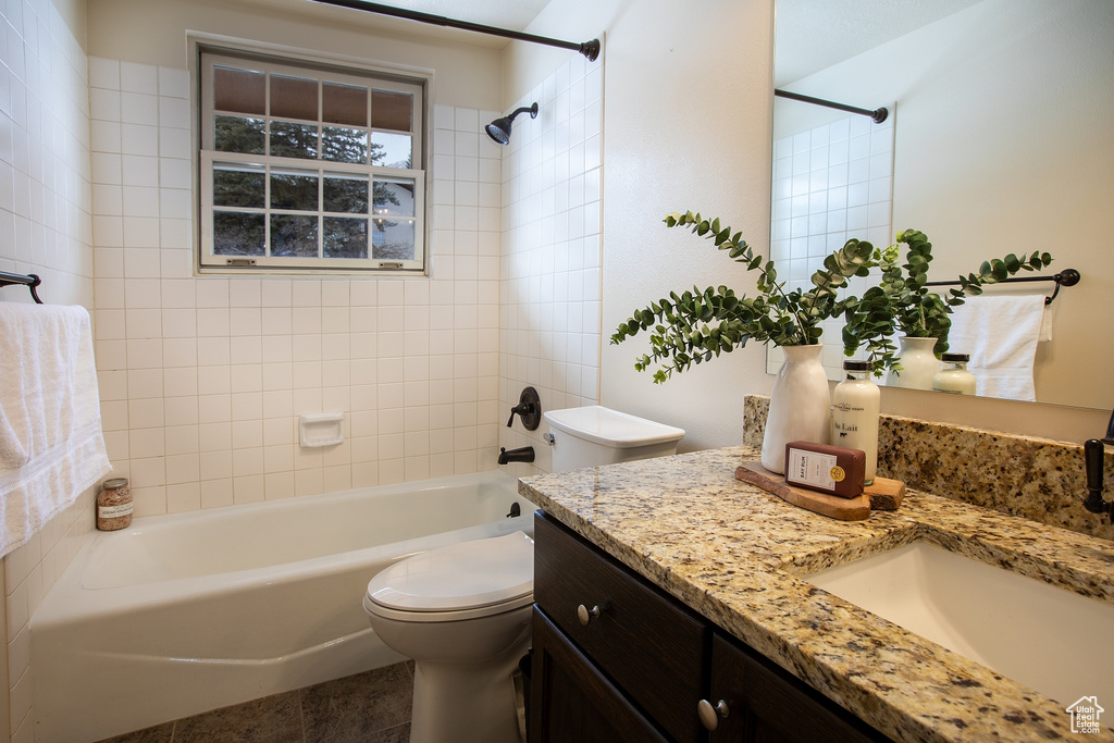 Bathroom with toilet, vanity, and bathtub / shower combination