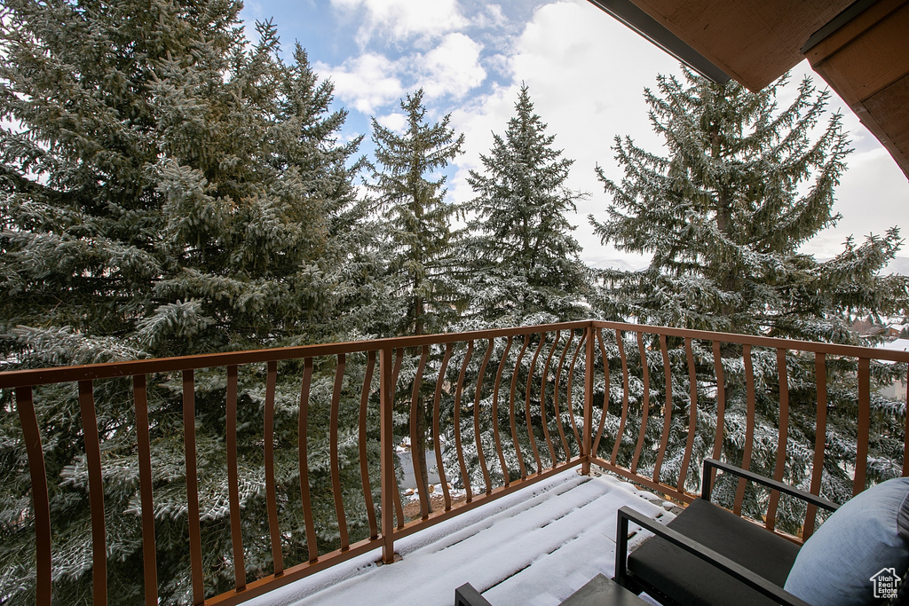 View of snow covered back of property