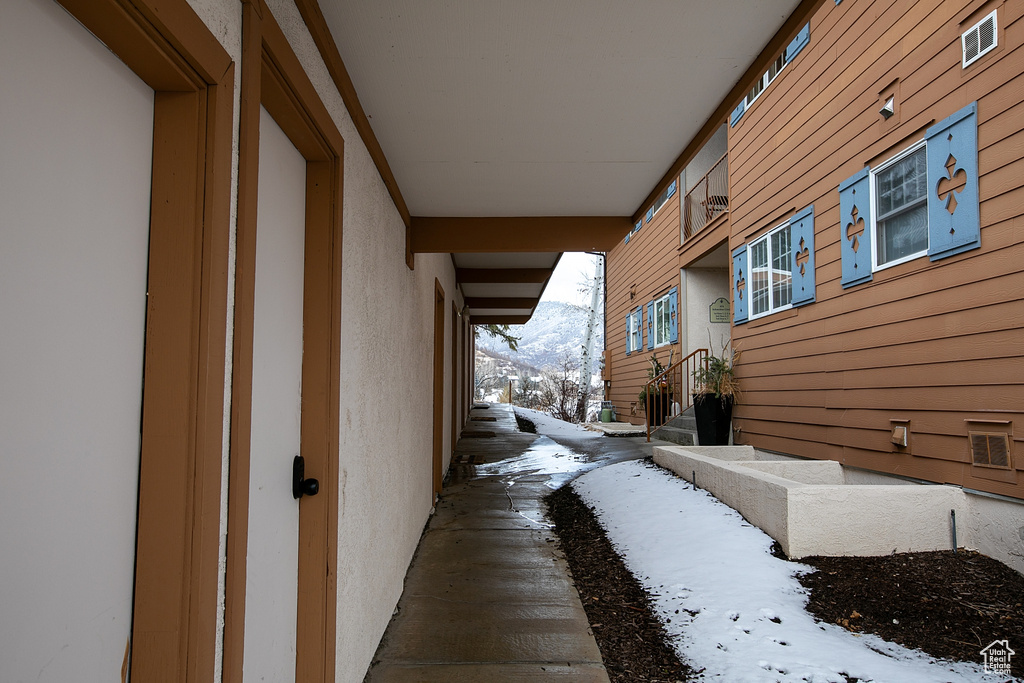 View of snowy exterior with a mountain view