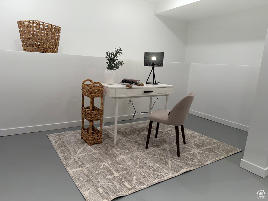 Office space with concrete floors and baseboards