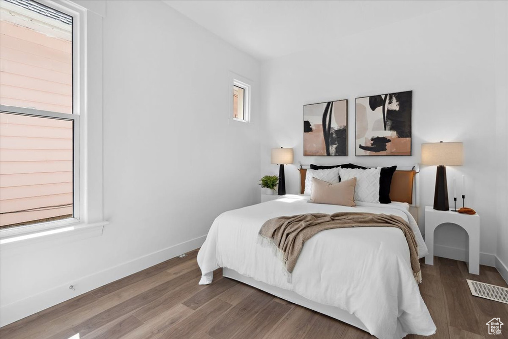 Bedroom with baseboards and wood finished floors