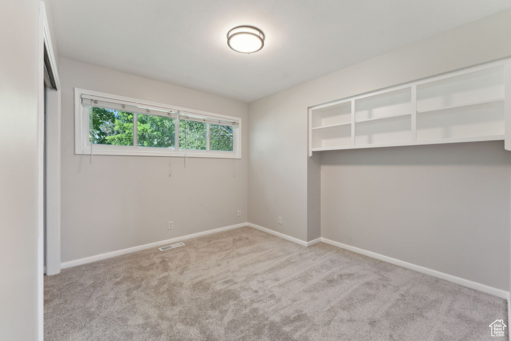 Unfurnished bedroom featuring carpet floors and baseboards