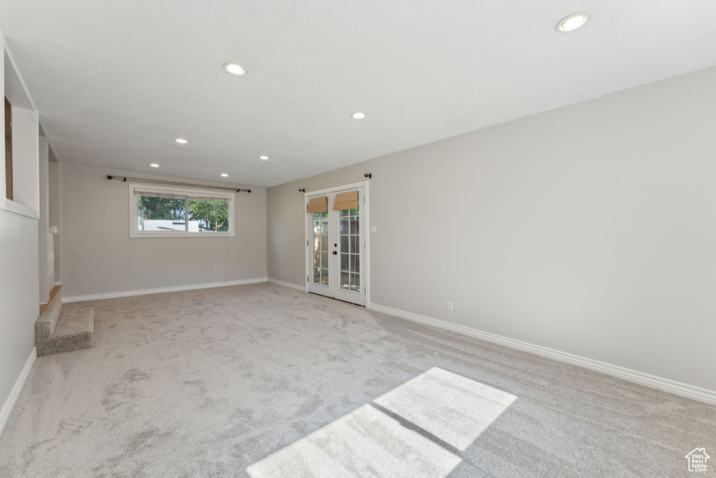 Empty room featuring recessed lighting, light carpet, and baseboards