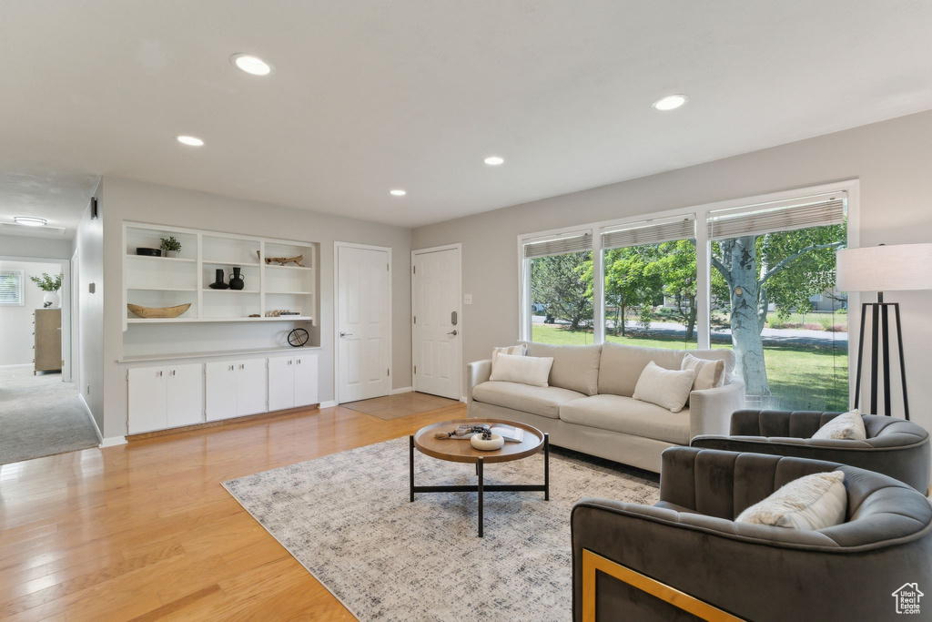 Living area with recessed lighting, light wood-type flooring, and baseboards