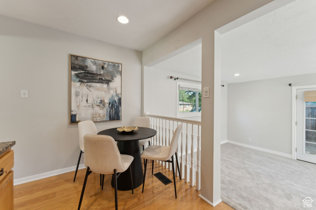 Dining space with baseboards, recessed lighting, and light wood-style floors