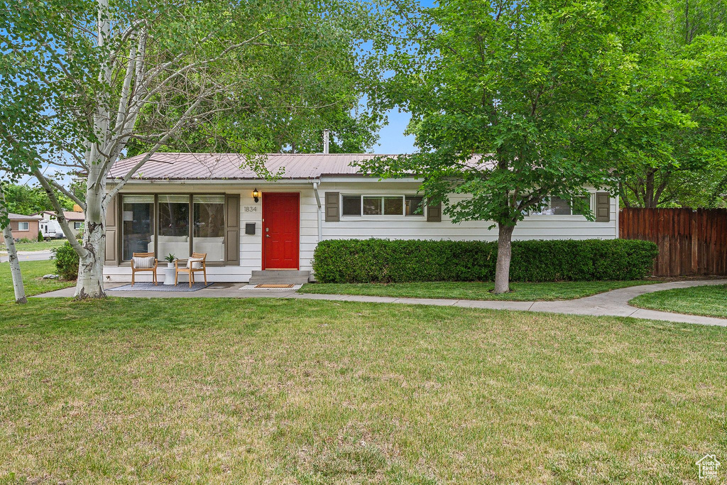 Ranch-style house with metal roof