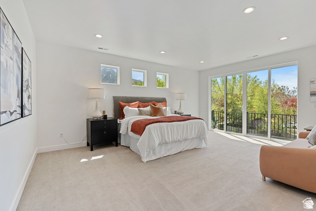 Carpeted bedroom featuring recessed lighting, baseboards, and access to exterior