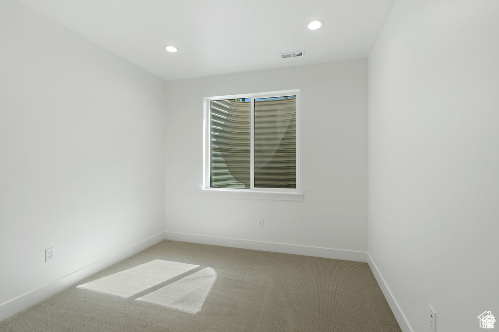 Unfurnished room with light colored carpet, recessed lighting, and baseboards