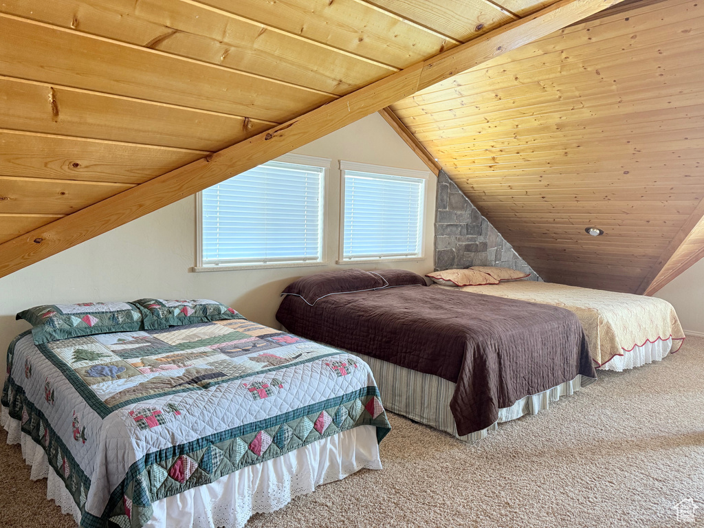 Bedroom with carpet, wood ceiling, and lofted ceiling
