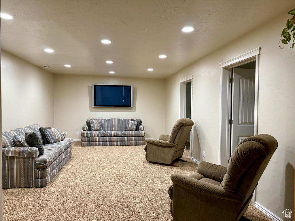 Living room with carpet floors, recessed lighting, and baseboards