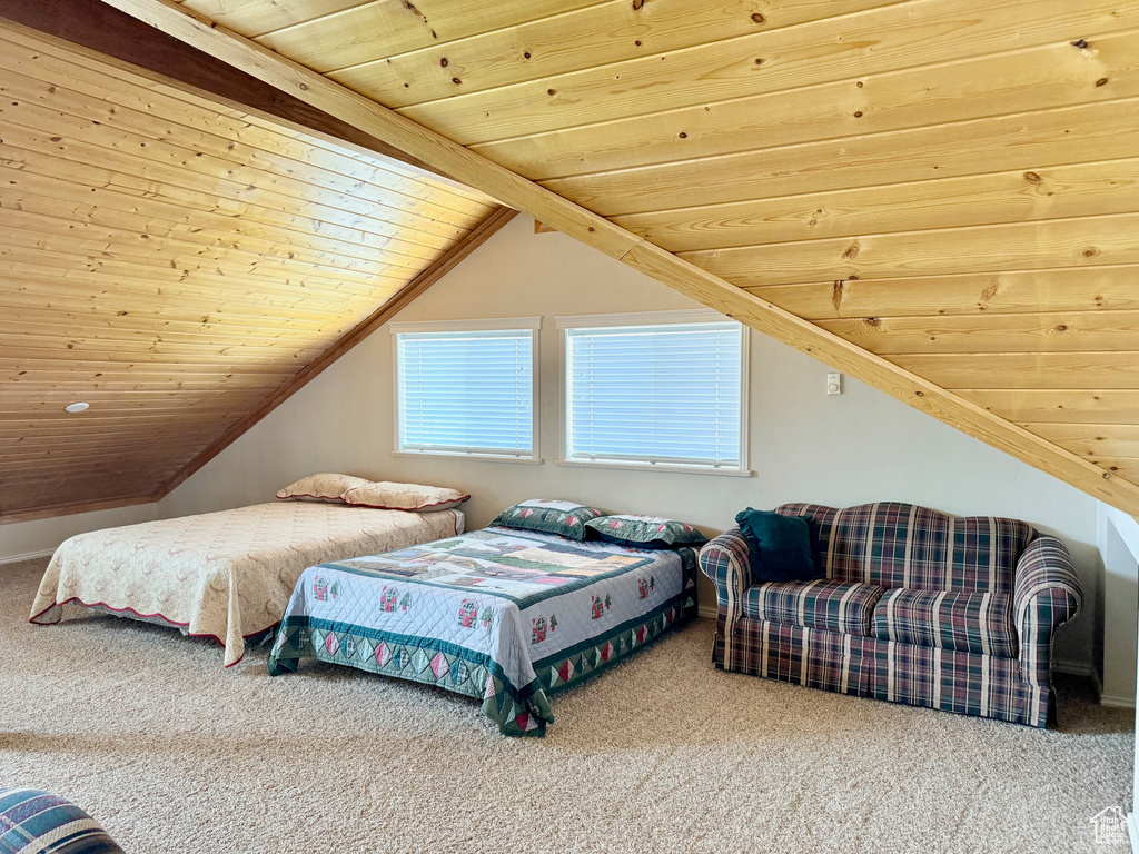 Bedroom featuring wood ceiling, carpet, and lofted ceiling