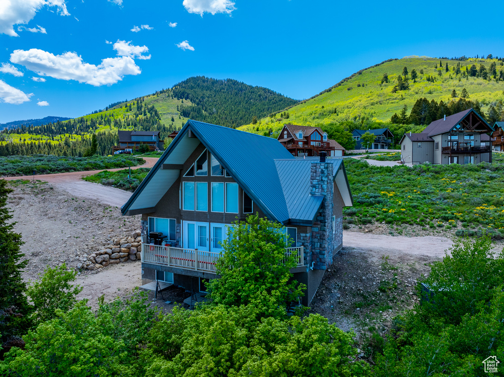 View of front of property with a mountain view, metal roof, and a standing seam roof