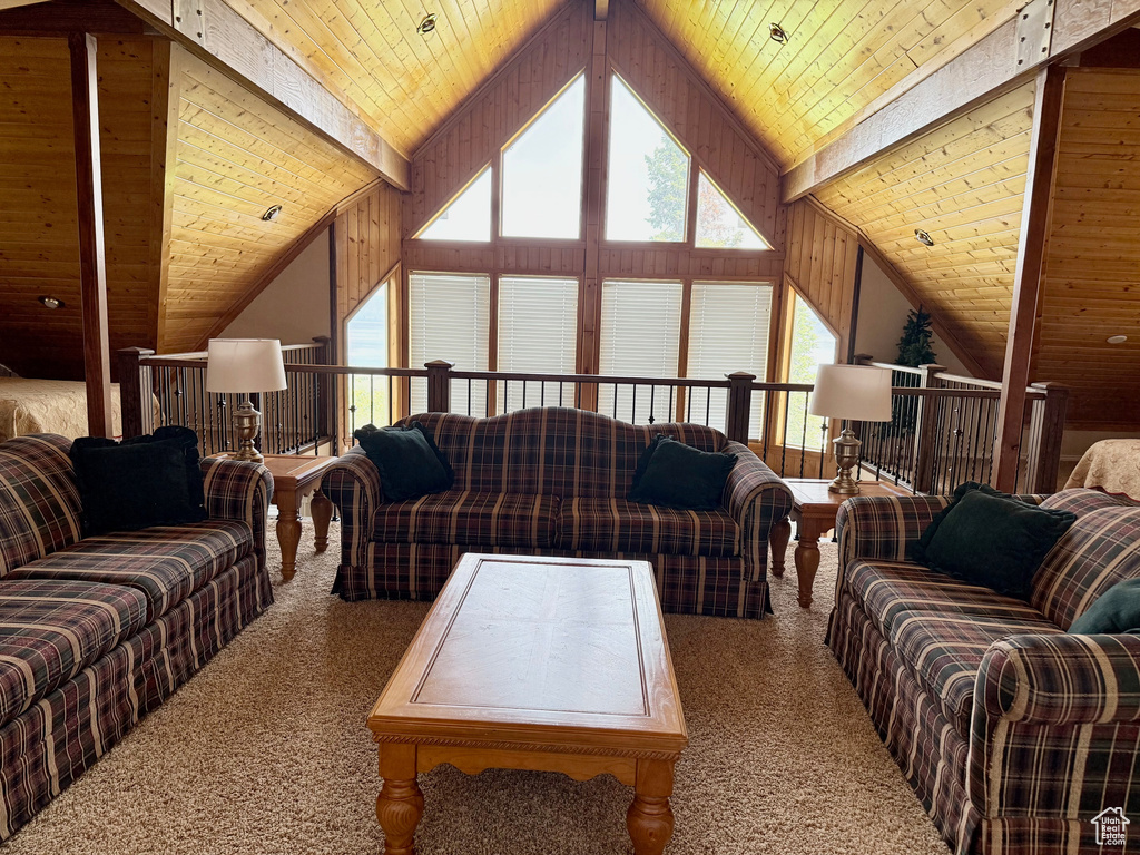 Carpeted living area with wood ceiling