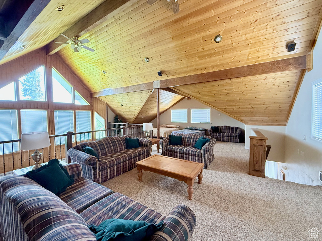 Carpeted living area with a ceiling fan and wood ceiling