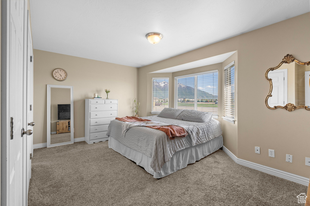 Bedroom featuring carpet flooring and baseboards