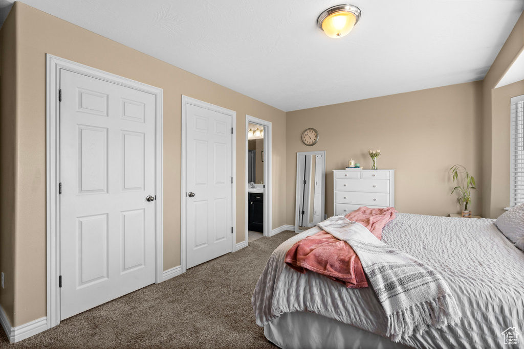 Carpeted bedroom featuring baseboards