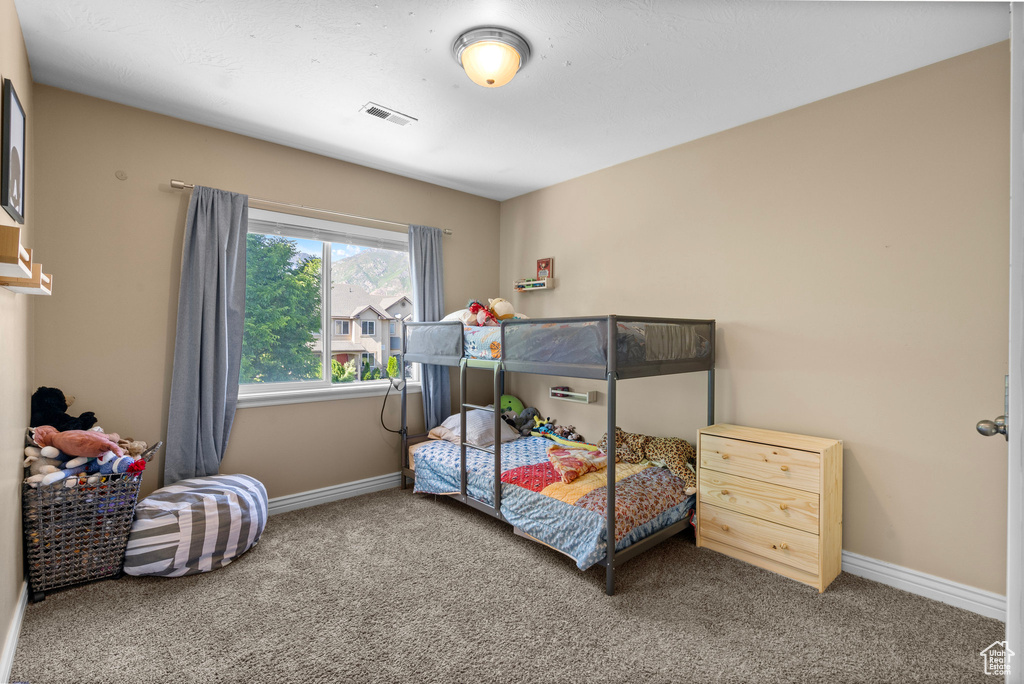 Bedroom featuring carpet flooring and baseboards