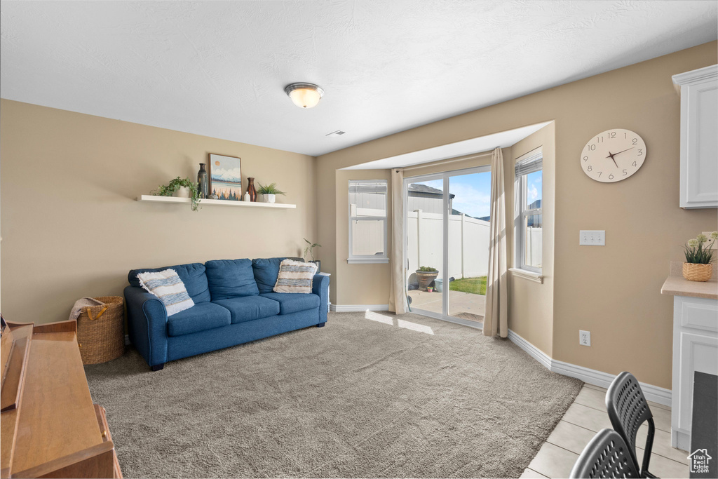 Living room featuring baseboards and light tile patterned floors