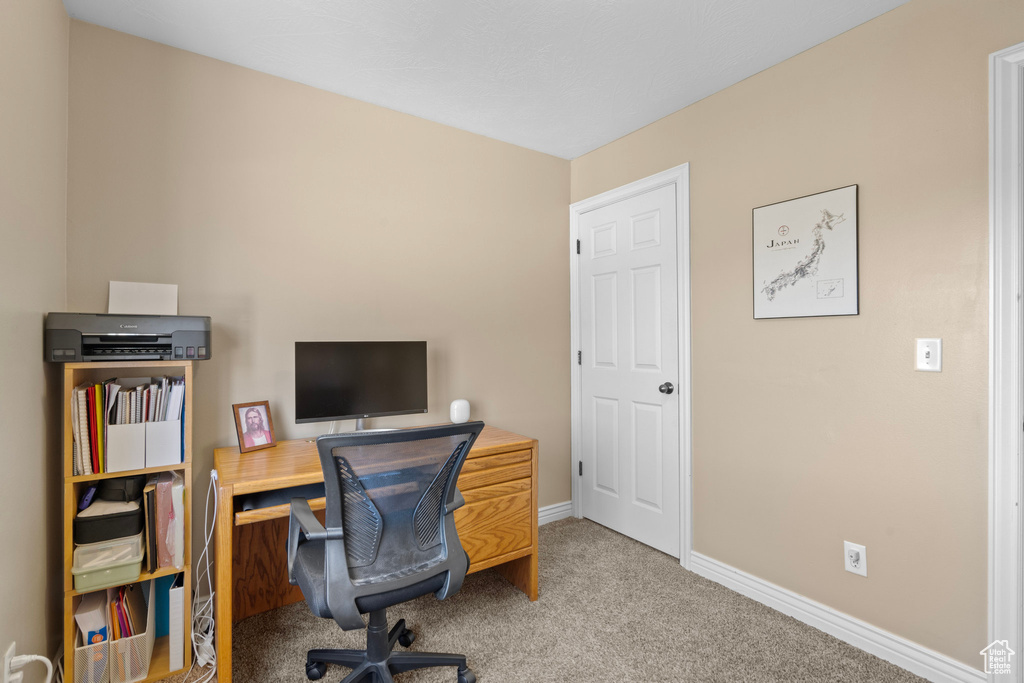 Office space with carpet flooring and baseboards